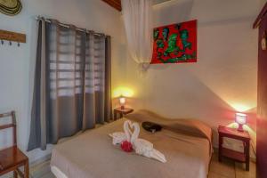 Postel nebo postele na pokoji v ubytování Antilles Liberte