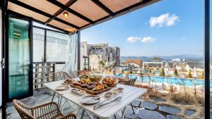 a table with a tray of food on top of a balcony at Gyeongju heybreeze Pool Villa in Gyeongju