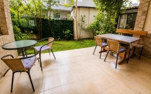 a patio with two tables and chairs and a table at The White Houses 7 in Nesebar