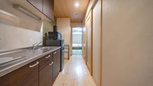a kitchen with a sink and a wooden floor at Stay Maison Hida Takayama in Takayama