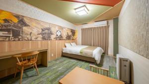 a hotel room with a bed and a desk at Stay Maison Hida Takayama in Takayama