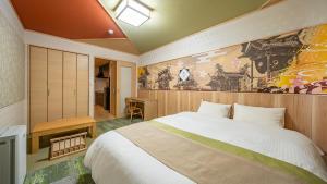 a bedroom with a bed and a painting on the wall at Stay Maison Hida Takayama in Takayama +21 photos