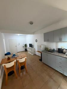 a kitchen with a table and chairs in a room at Departamento en Ezeiza - SA in La Unión +8 photos