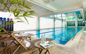 a large swimming pool with a table and a table sidx sidx at LIDO FORESTRY SPA RESORT in Yangmei