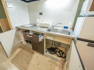 a kitchen with a sink and a counter top at Stay Maison Hida Takayama in Takayama