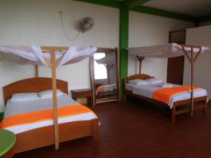 Postel nebo postele na pokoji v ubytování Tambopata Hostel