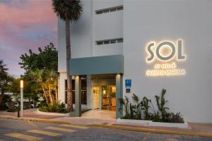 a building with a sign on the side of it at SOL by Meliá Puerto Marina in Torremolinos