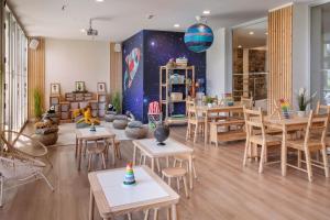 a room with tables and chairs and a wall with a planet at SOL by Meliá Puerto Marina in Torremolinos +59 photos