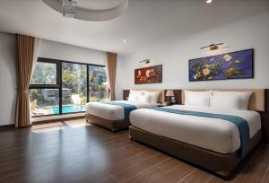 a hotel room with two beds and a large window at Cát Bà Sena Valley Retreat in Xuan Dam +58 photos