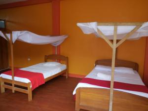 Postel nebo postele na pokoji v ubytování Tambopata Hostel