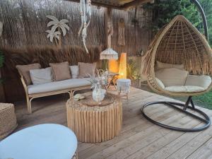 a patio with a couch and a chair and a table at Grand Villa Nefeli - Private Spa in Lagonissi