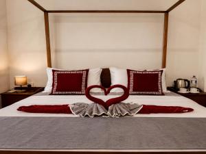 a bed with a red heart on top of it at Krautergarten Resort & Wellness in Negombo
