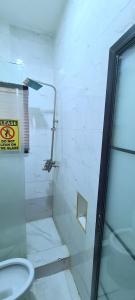 a bathroom with a glass shower and a toilet at Kiarra Suites Owerri in Owerri +16 photos