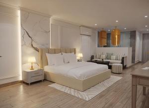 a bedroom with a bed and a living room at My Eliana Luxury Hotel Saigon Saigon & Spa in Ho Chi Minh City