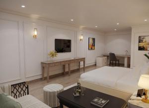 a hotel room with a bed and a desk at My Eliana Luxury Hotel Saigon Saigon & Spa in Ho Chi Minh City