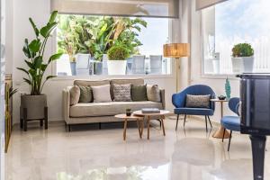 a living room with a couch and tables and plants at Hotel Las Arenas, Affiliated by Meliá in Benalmádena