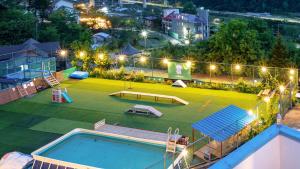 an outdoor playground with a swimming pool at night at Chuncheon Dogandstay in Chuncheon