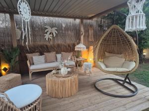 a patio with a swing chair and a table at Grand Villa Nefeli - Private Spa in Lagonissi