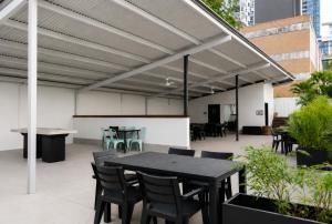 a patio with a table and chairs under awning at Punthill Spring Hill in Brisbane +12 photos