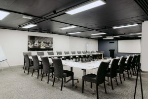 a conference room with a long table and chairs at Punthill Spring Hill in Brisbane