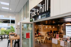 a restaurant with tables and chairs in a building at Punthill Spring Hill in Brisbane
