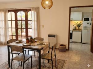 a kitchen and dining room with a table and chairs at Avellaneda in Mendoza