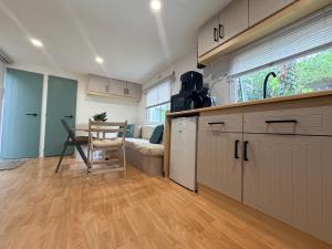 a kitchen with a table and a couch in a room at Mobile Home WT 1906 in Saint-Pierre-dʼOléron