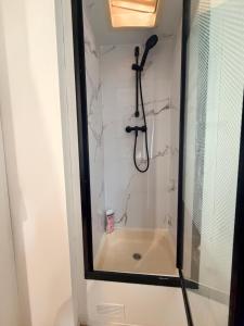 a bathroom with a shower and a bath tub at Mobile Home WT 1906 in Saint-Pierre-dʼOléron