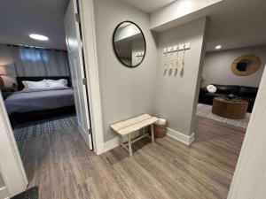 a small bedroom with a bed and a mirror at Private lux lower level flat fully fenced in Twin Falls