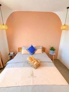 a bedroom with a large bed with two tables at La Riva Riverside Hue Hotel & Rooftop in Hue