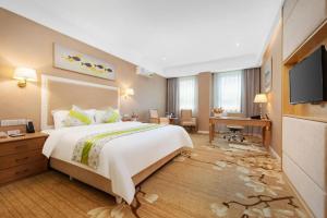 a hotel room with a large bed and a flat screen tv at Catic Hotel--Adjacent Buliding in Zhuhai +234 photos
