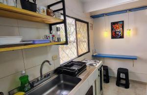 a kitchen with a sink and a stove and a window at Guadalia Living Smr in Santa Marta +58 photos
