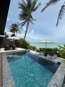 a swimming pool with a view of the ocean at Villa Miario in Koh Samui