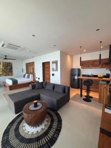 a large living room with a couch and a table at Villa Miario in Koh Samui