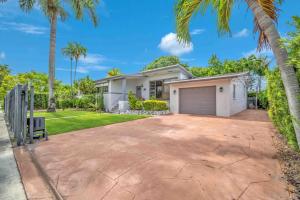 a house with a garage and palm trees at Modern Miami Oversized 3 Bedroom in Central Location in Miami