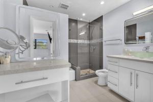 a white bathroom with a shower and a sink and a toilet at Modern Miami Oversized 3 Bedroom in Central Location in Miami +35 photos