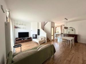 a living room with a couch and a table at Nice villa with pool and garden in Fermignano