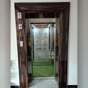 a doorway into a building with a glass door at Hotel sphatic in Chitrakoot +14 photos