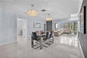 a dining room and living room with a table and chairs at Modern Miami Oversized 3 Bedroom in Central Location in Miami