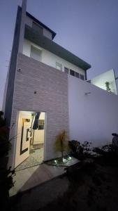 a large white building with a large door at Olas de San Marino in Harry Manzo