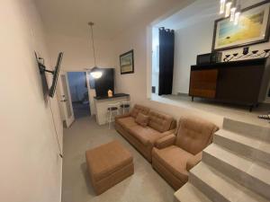 a living room with a couch and a piano at Olas de San Marino in Harry Manzo +9 photos