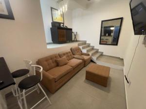 a living room with a couch and a set of stairs at Olas de San Marino in Harry Manzo