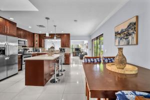a kitchen with a wooden table and a dining room at Modern Miami Oversized 3 Bedroom in Central Location in Miami