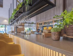 a bar in a restaurant with plants on the counter at INNSiDE by Meliá Valencia Oceanic in Valencia