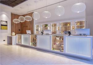 a store with white counters and pendant lights at INNSiDE by Meliá Valencia Oceanic in Valencia