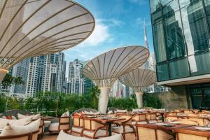 a restaurant with tables and chairs with a city in the background at ME by Meliá Dubai in Dubai
