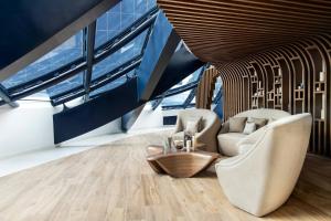 a living room with two chairs and a table at ME by Meliá Dubai in Dubai +135 photos