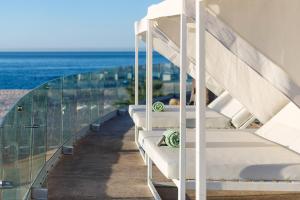 a balcony with white bunk beds and the ocean at Paradisus by Meliá Los Cabos - Adults Only - All Inclusive in San José del Cabo