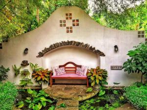 a patio with a red bench in a wall at Boutique Villa with a Pool in Kandy