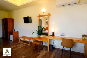 a hotel room with a desk and a bed at Marabedda Gardens Resort in Rikillagaskada